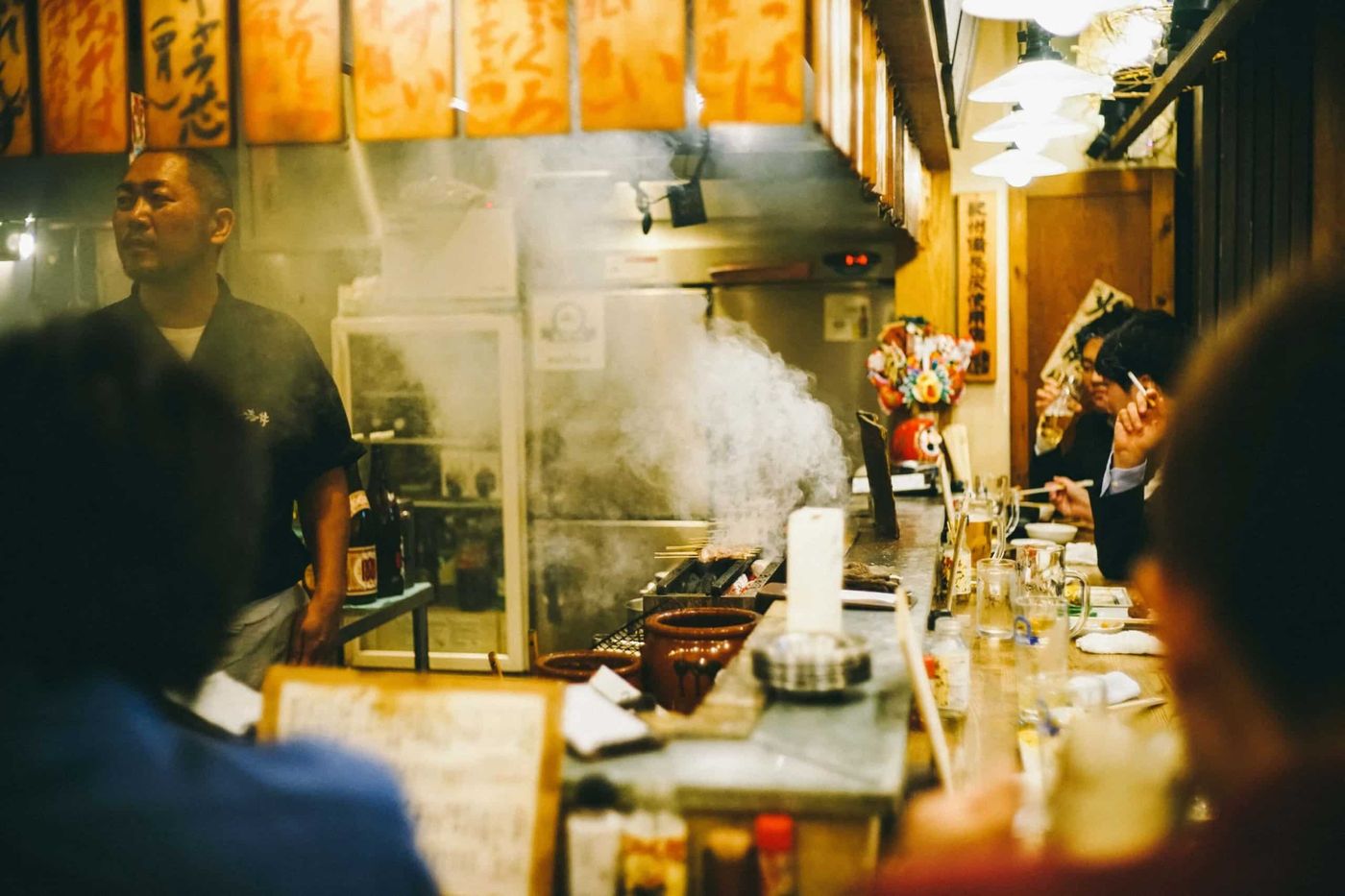 焼き鳥の煙が立ち込める本物の日本の居酒屋カウンター